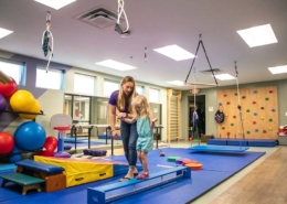 patient using the therapy gym to practice motor skills